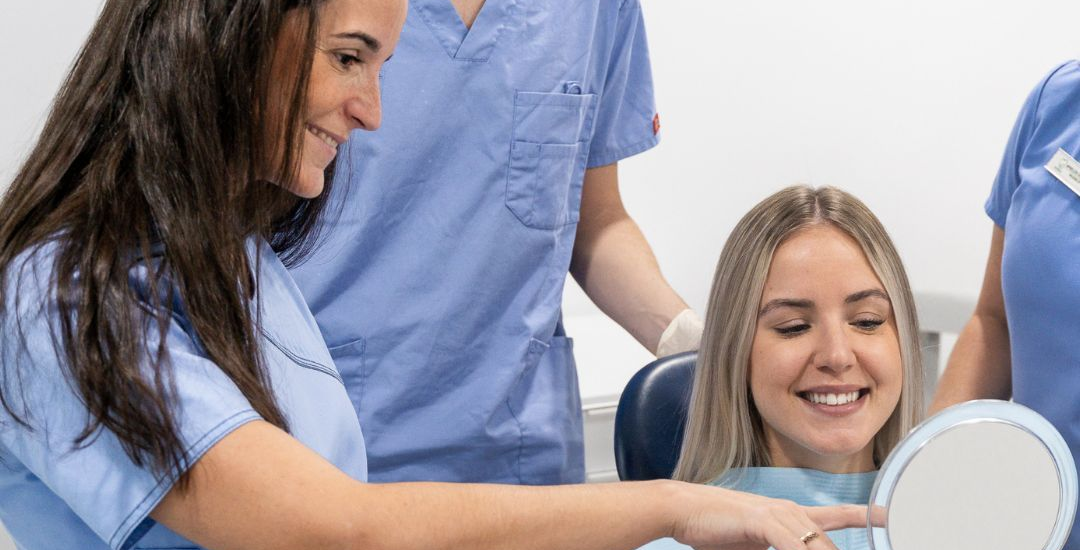 Dentist explaining the connection between oral health and overall wellness.